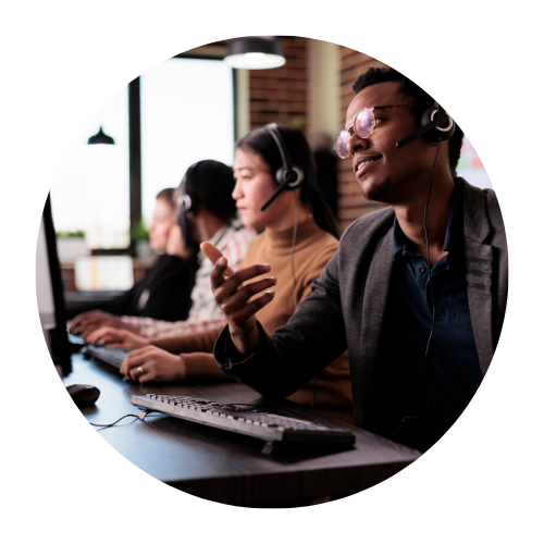 Three individuals sitting in front of desktop computers in an office environment. Their faces are obscured by brown rectangles, maintaining their privacy. The setting appears to be a professional workspace, possibly indicating a collaborative or customer service setting.
Mission Control NOC and HelpDesk, Helpdesk Services, SLA, MSP, Outsources MSP, MSP Services, Helpdesk, IT Services